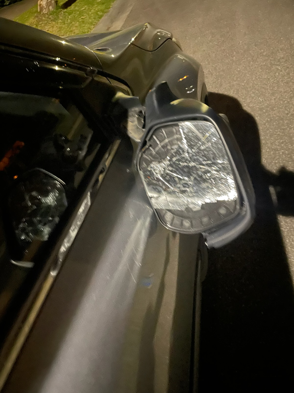 Complete side mirror detached from the vehicle door and requiring replacement